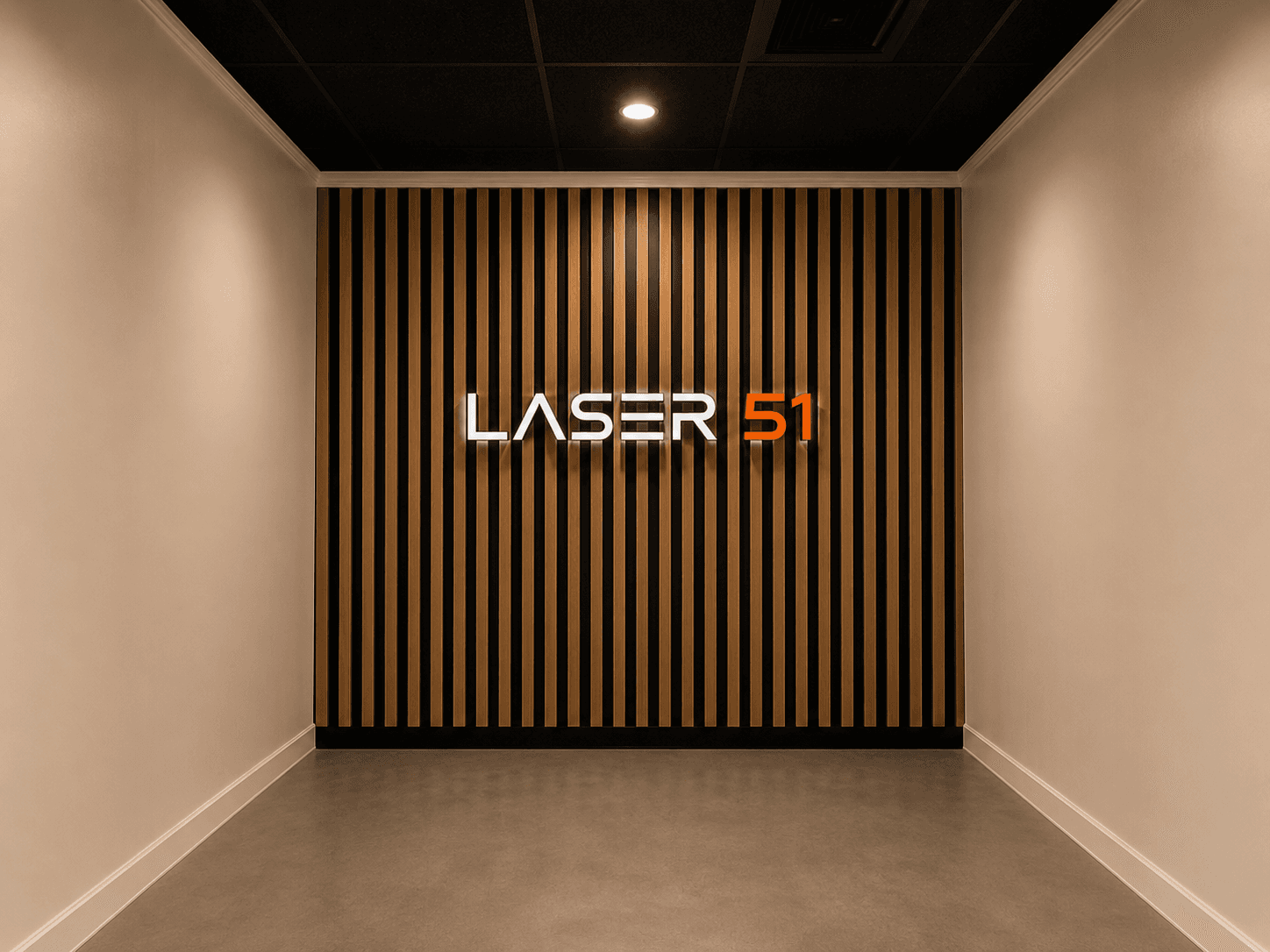 Modern hallway with a wood-slat wall displaying a white and orange LASER 51 sign.